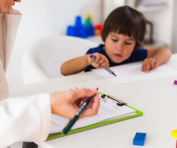 Child psychology, little boy talking to psychologist