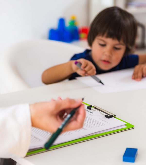 Child psychology, little boy talking to psychologist