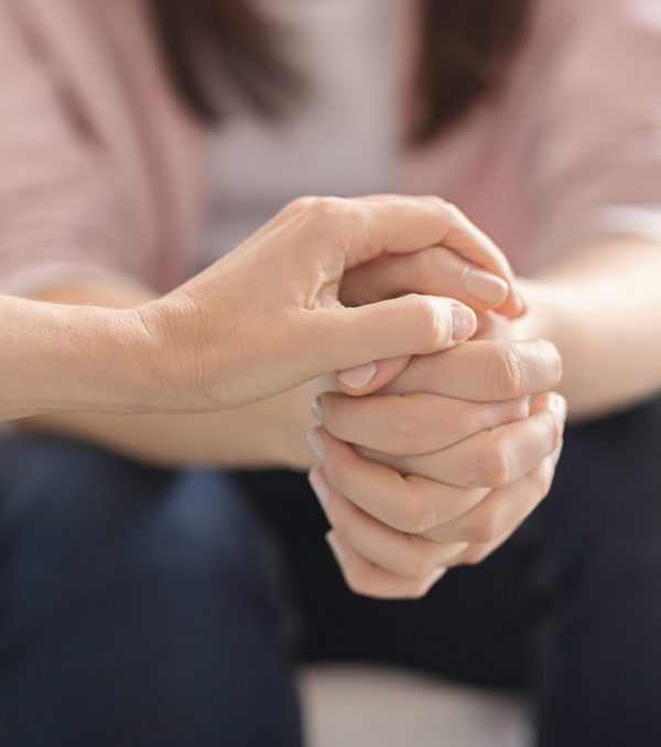 Loneliness, despair, depression concept. Close up of therapist touching woman patient hands during session