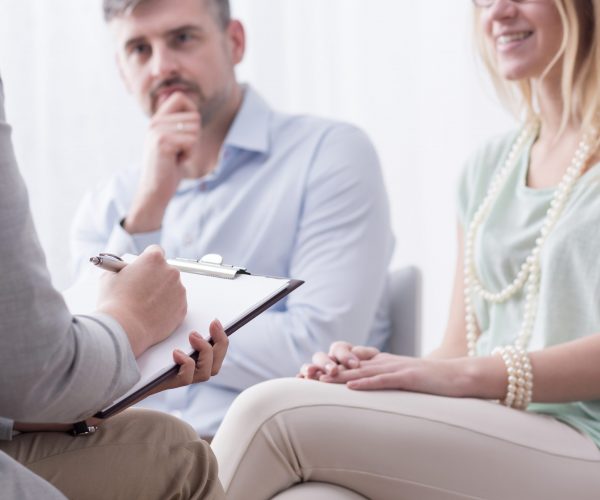 Young woman and her husband taking advice at psychiatrist